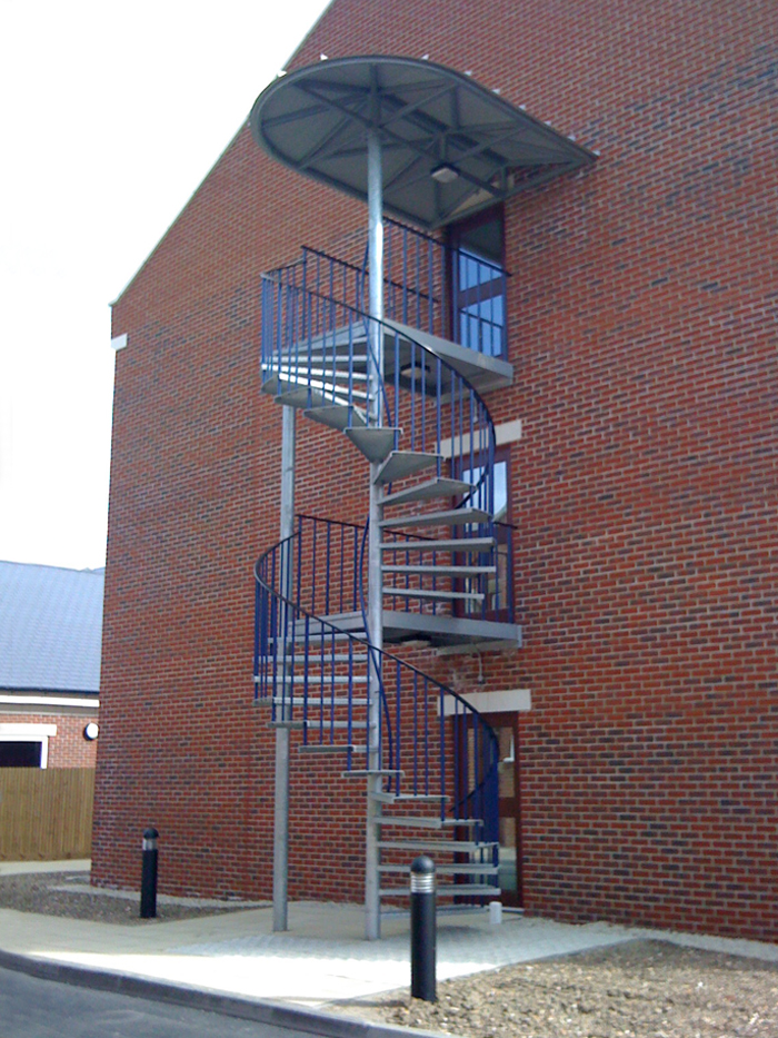 Galvanised spiral staircase with canopy to a new accommodation block in Portsmouth.