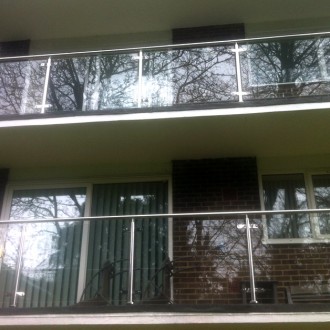 New stainless steel balustrades with glass infills to a large block of flats in Dorset.