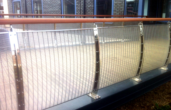 Curved stainless steel balustrading with timber handrail on galvanised mild steel link bridge.