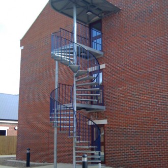 Galvanised spiral staircase with canopy to a new accommodation block in Portsmouth.
