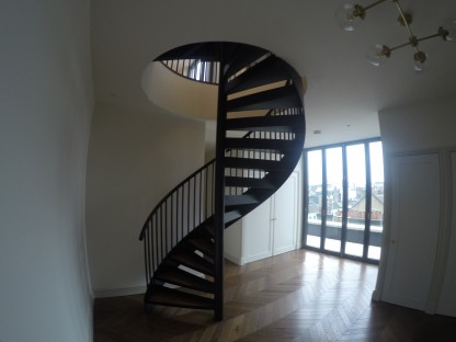 Bespoke Black Mild Steel Spiral Staircase for residential penthouse apartment in London.