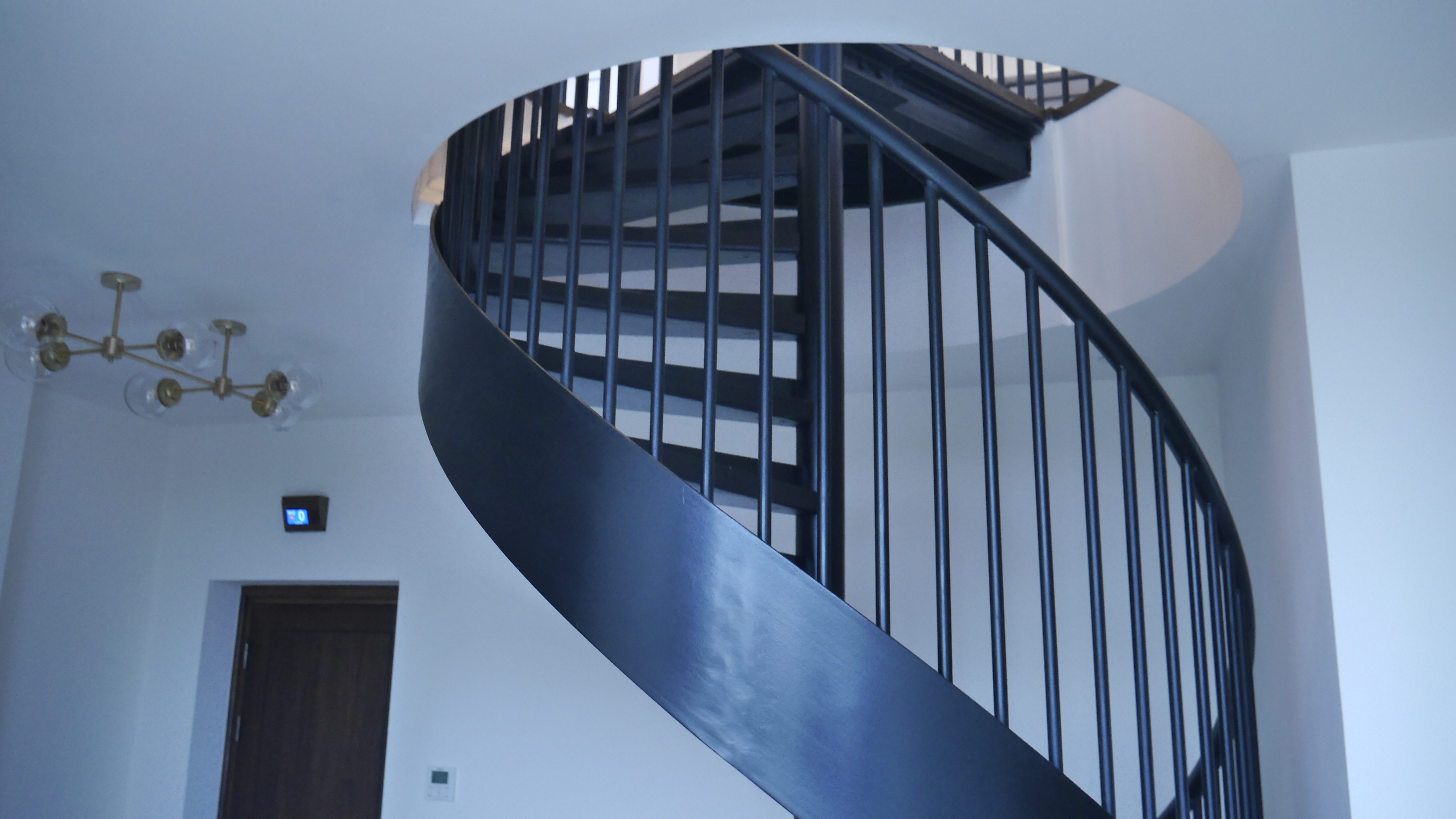 Bespoke Black Mild Steel Spiral Staircase for residential penthouse apartment in London.